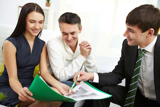 portrait of modern couple listening to manager explanation of mortgage conditions