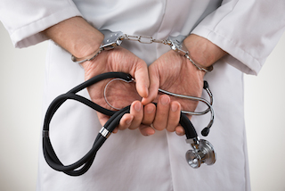 doctor hands in handcuffs
