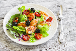 fresh salad with chicken breast, sun-dried tomatoes, green salad